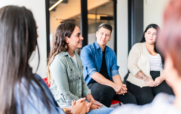 4 people sitting in a group therapy session